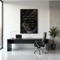 Success Offends motivational print styled on a wall above a desk